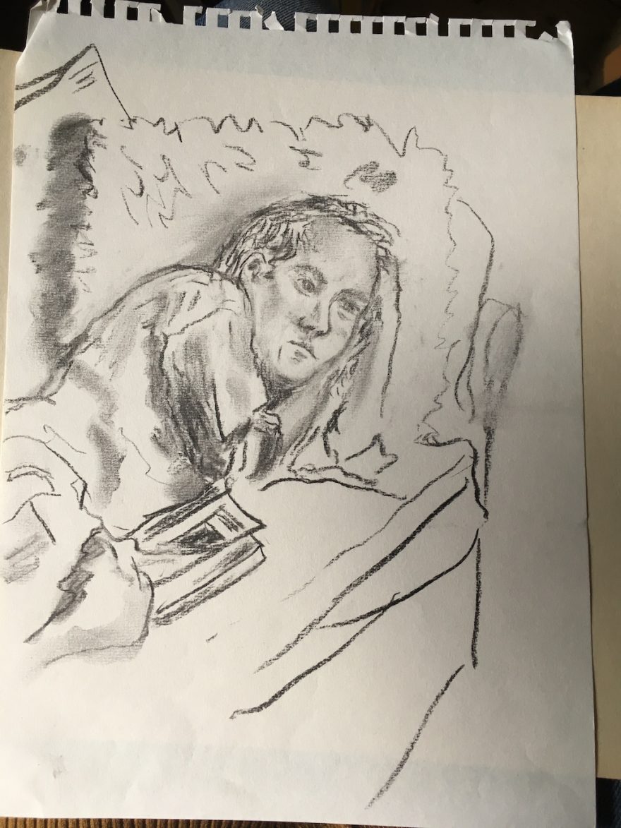 a person lying on a couch with a book
